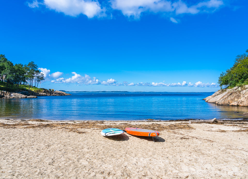 Orange and blue paddle board in the Atlantic Ocean bay Massachusetts