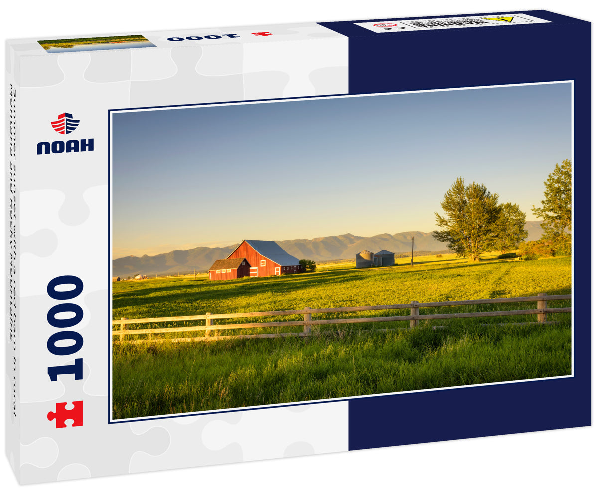 Summer sunset with a red barn in rural Montana and Rocky Mountains