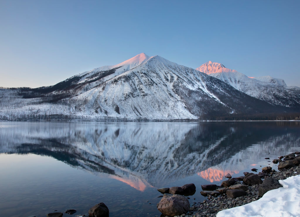 Lake McDonald sunset mountain peaks and reflection in Glacier National Park, Montana, USA