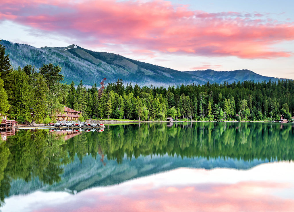 Lake McDonald with a vibrant colorful sunrise in Glacier National Park Montana