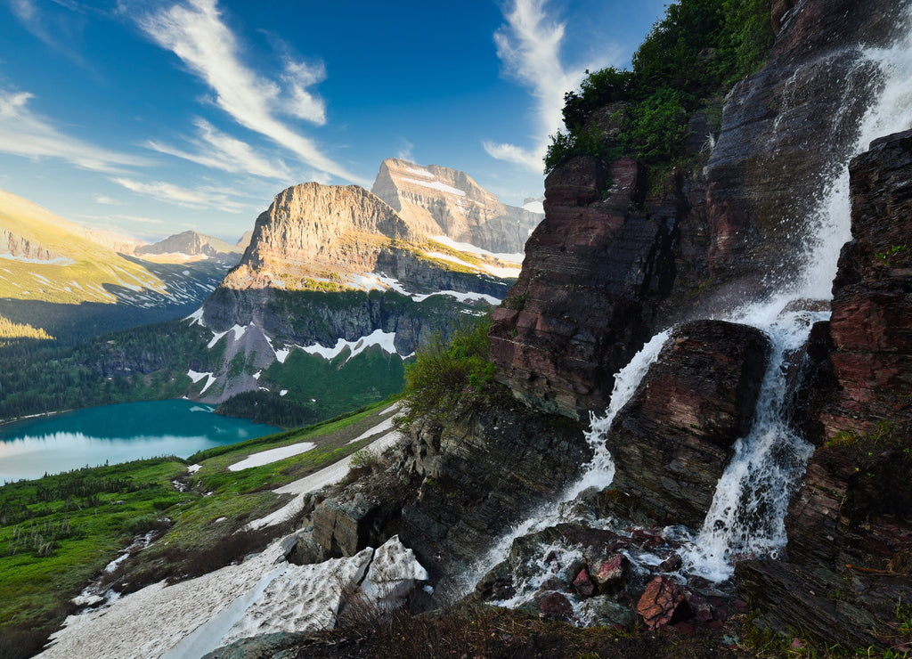 Scenic view on waterfall, Grinnell lake and mountains in Glacier National Park Montana