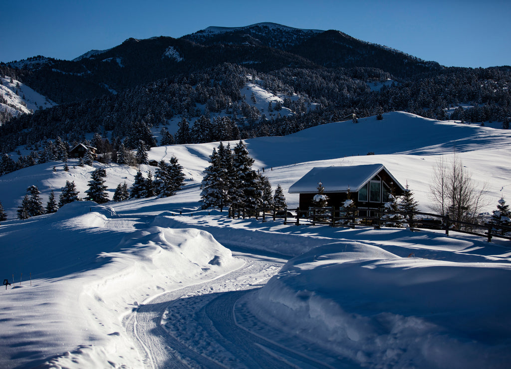 Lonely snowed in winter cabin in the Bridger Mountain foothills, Bozeman, Montana