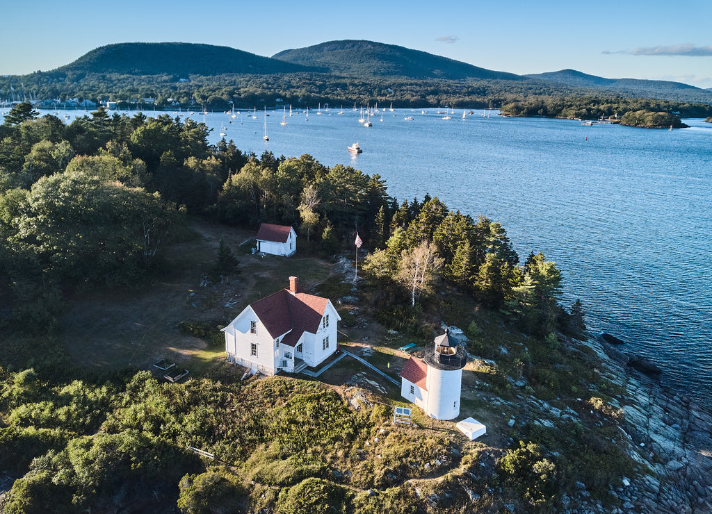 Aerial Drone image of the Curtis Island Lighthouse att he entrance to Camden Harbor on Penobscot Bay in Maine on a late afternoon