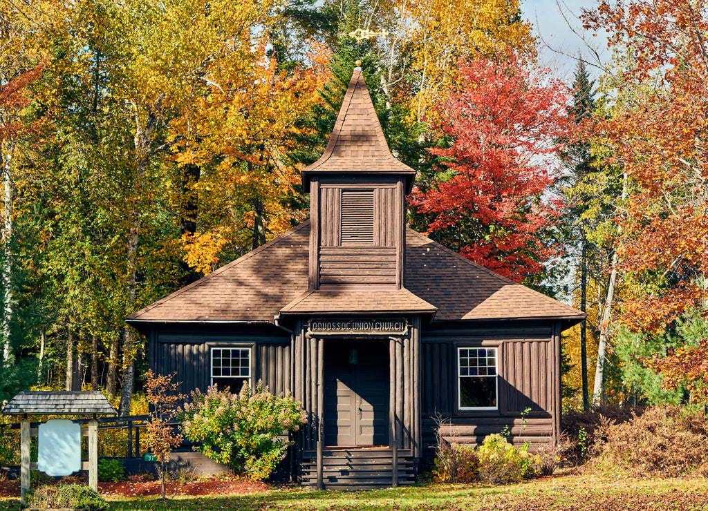 Very old log church at autumn. Oquossoc, Maine, USA