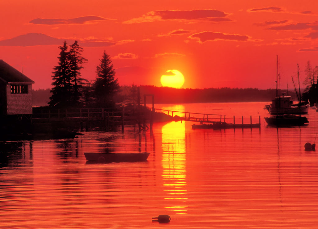 Brilliant red sky and sunset over harbor, Port Clyde Maine