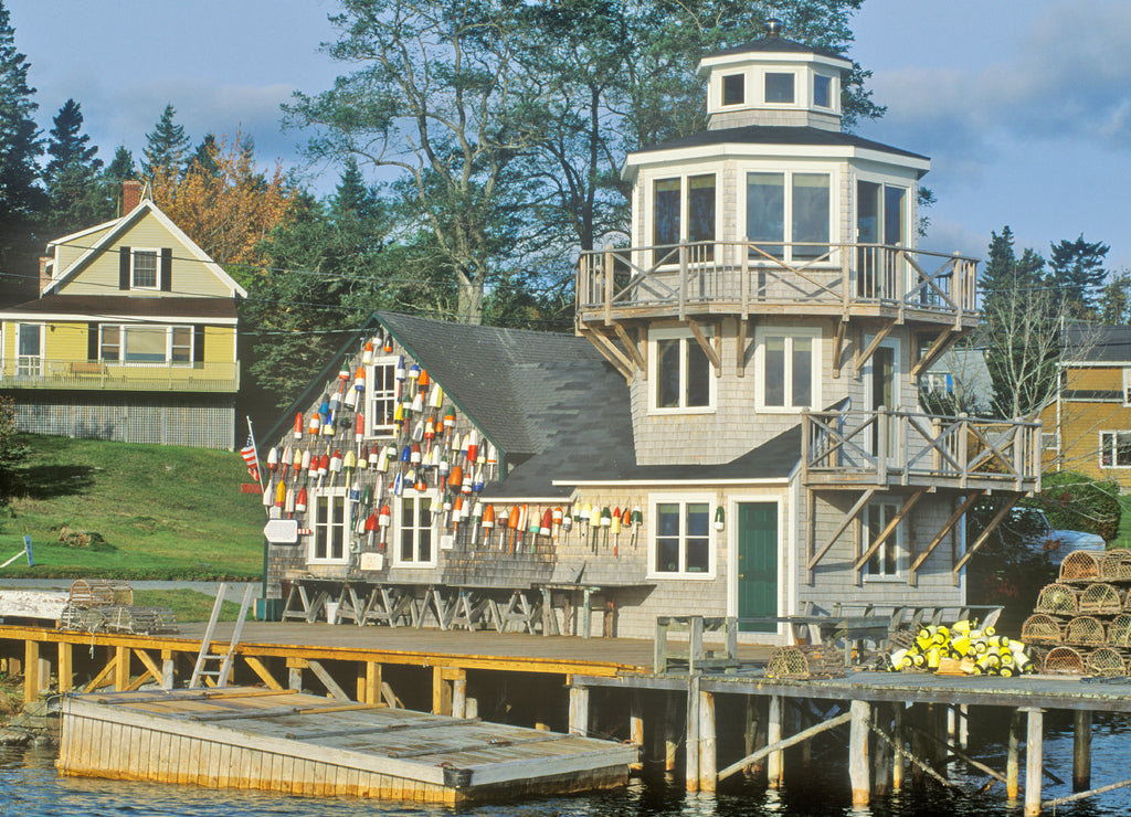 Floats from fishing nets hang on the side of a lighthouse in Stonington, Mount Desert Island, Maine