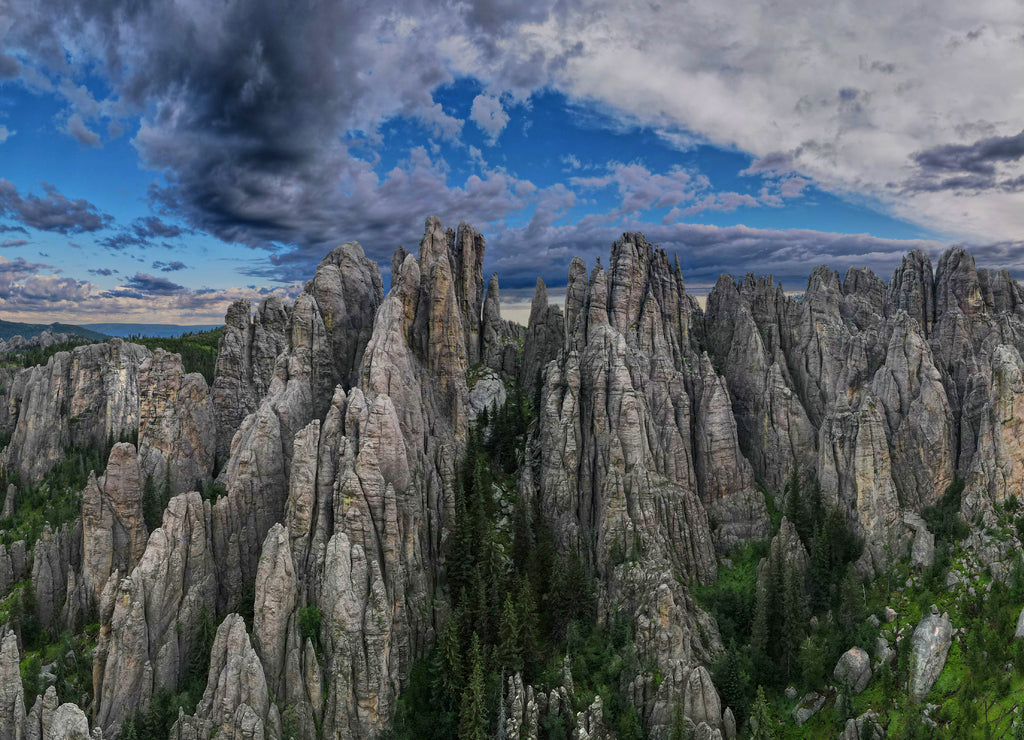 panorama of needles spires with storm clouds in the background off needles highway in black hills of South Dakota