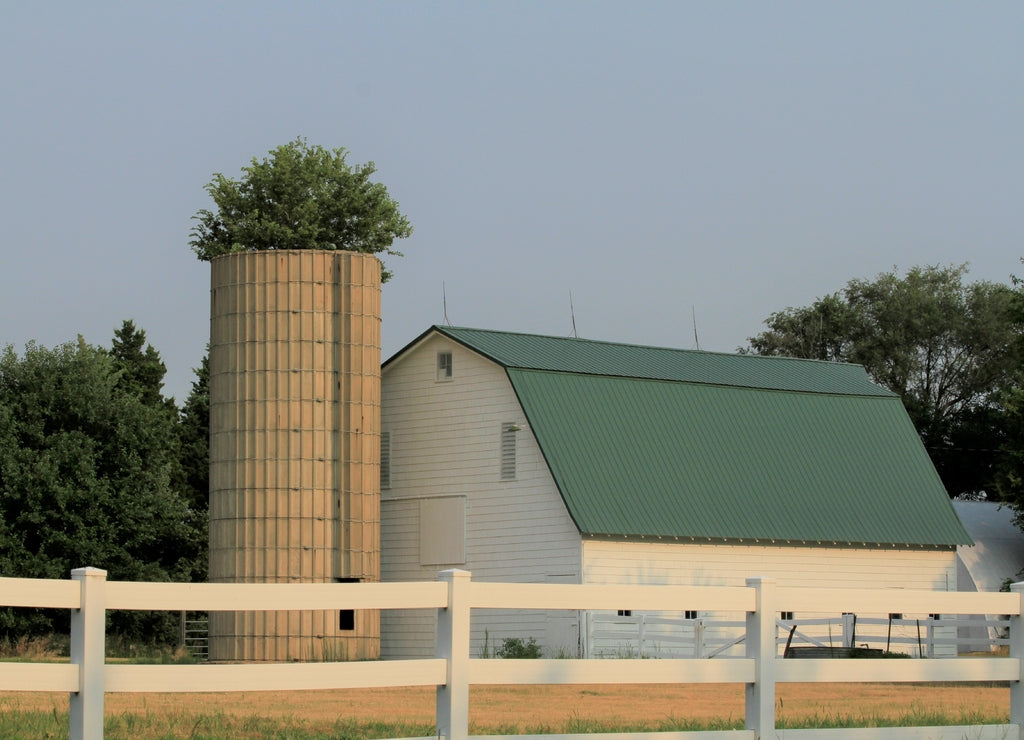 barn and silo on a farm that's bright and colorful north of Lyons Kansas USA out in the countr