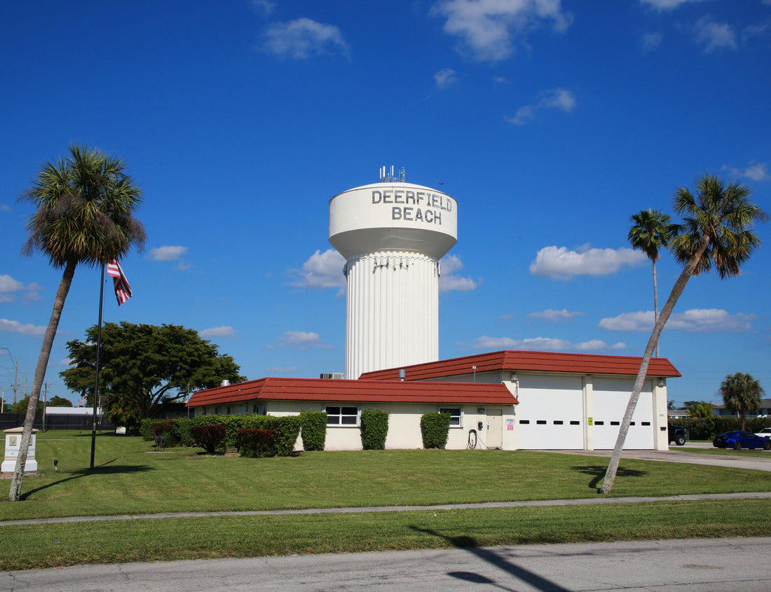 Noah Jigsaw Puzzle Deerfield Beach Water Tower Identifying Sign at Broward Sheriff and Fire Station Framed by Two Palm Trees, a Sidewalk and the Street in a Sunny Day in January 1000 pieces