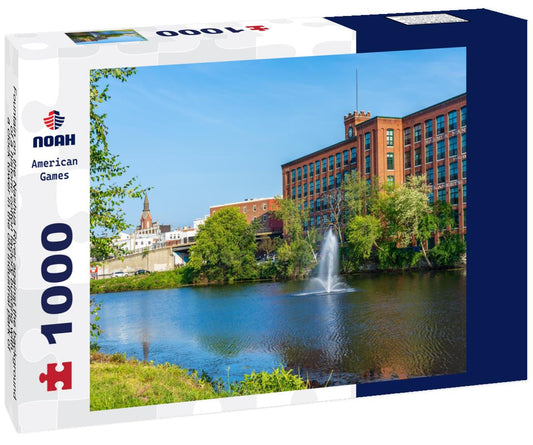 Noah Jigsaw Puzzle Fountain on the Nashua River against the background of a historic cotton factory building with a clock tower in the old industrial park of Nashua. New Hampshire, USA 1000 pieces