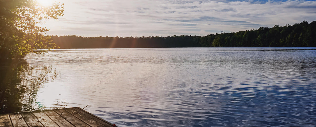 The sun rising in Chesapeake, Virginia USA at a local park with a lake 2000pc Panoramic Puzzle