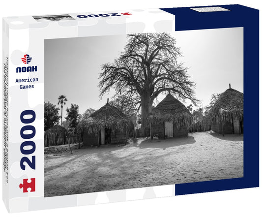 Noah Jigsaw Puzzle Traditional village houses with a baobab tree in the background in Senegal, Africa. The baobab tree is revered in Senegal, where it is the nation's symbol in black white 2000 pieces