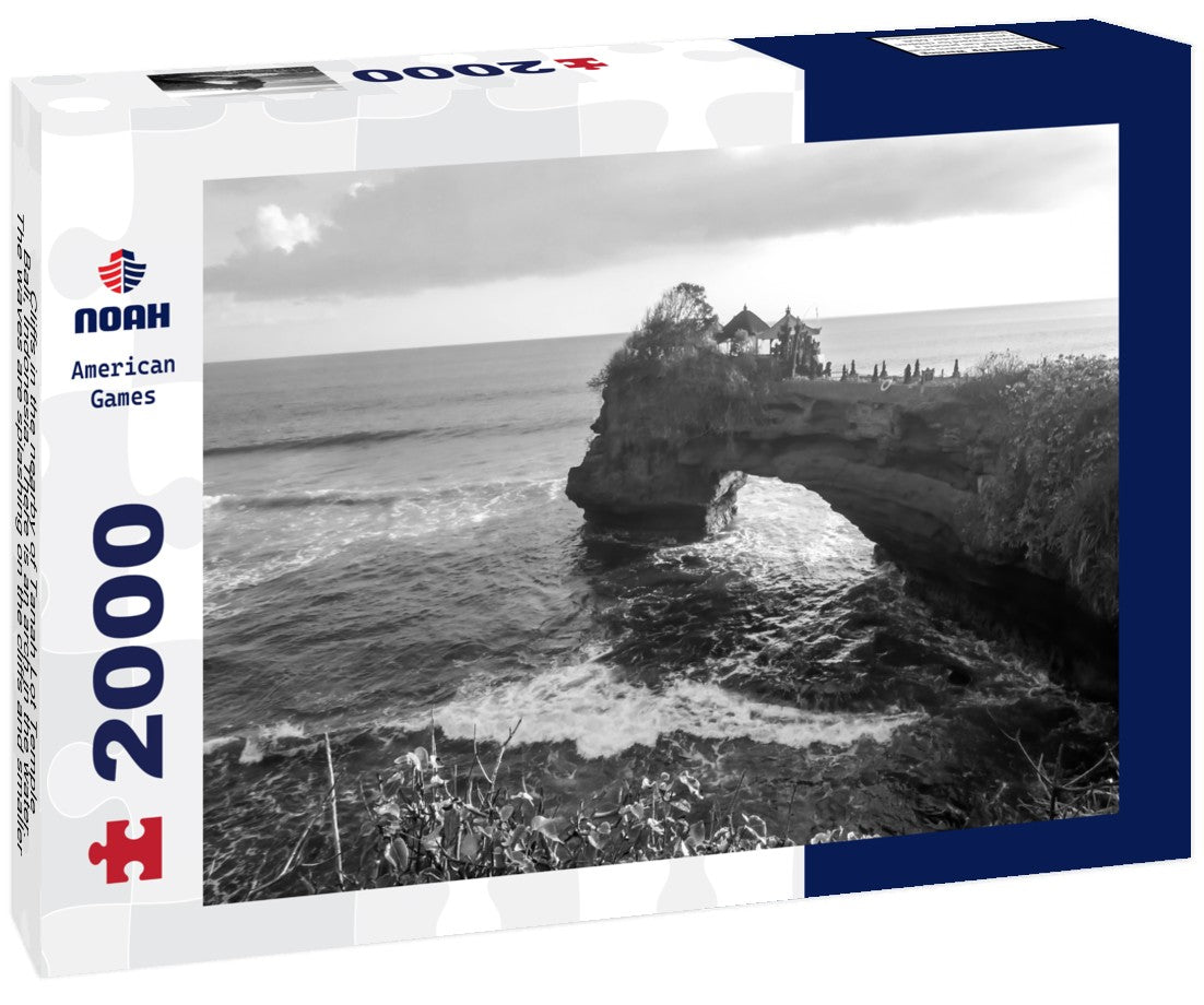 Cliffs in the nearby of Tanah Lot Temple, Bali, Indonesia. There is an arch in the water. The waves are splashing on the cliffs and smaller rocks. Water stays on the flat surfaces. Power of the nature 2000pc PuzzleBlack and White