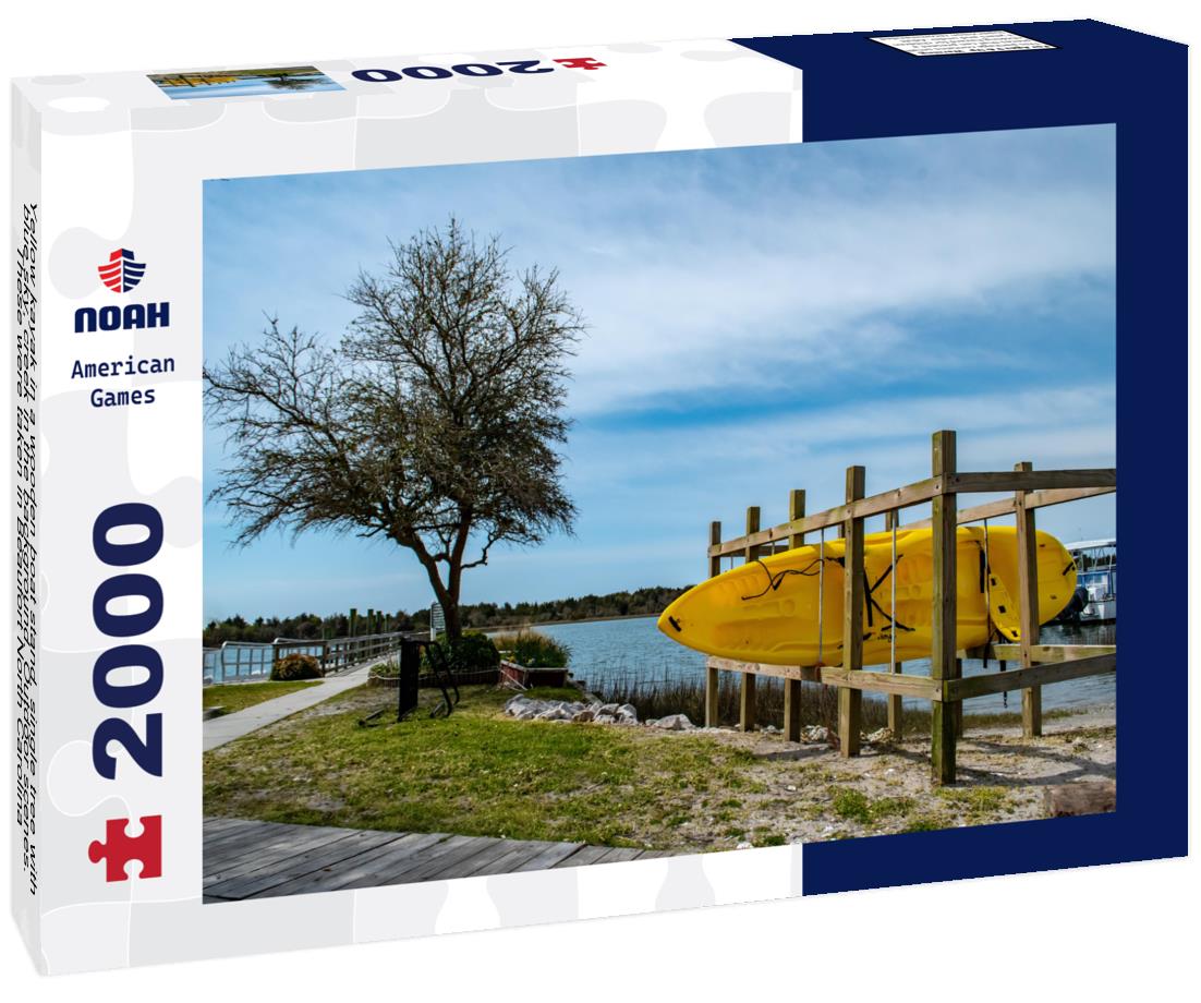Noah Jigsaw Puzzle Yellow kayak in a wooden boat stand, single tree with blue sky, creek in the background. Outdoor scenes. These were taken in Beaufort North Carolina 2000 pieces