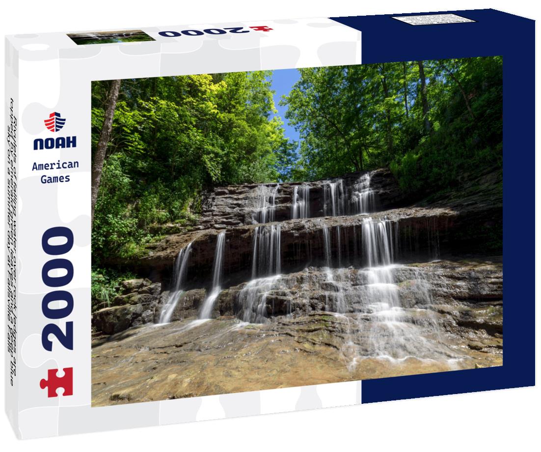 Noah Jigsaw Puzzle Rivulets of falling water over rock ledges are topped by emerald green leaves and a deep blue sky on a summer day at Fallsville Falls, Ohio 2000 pieces