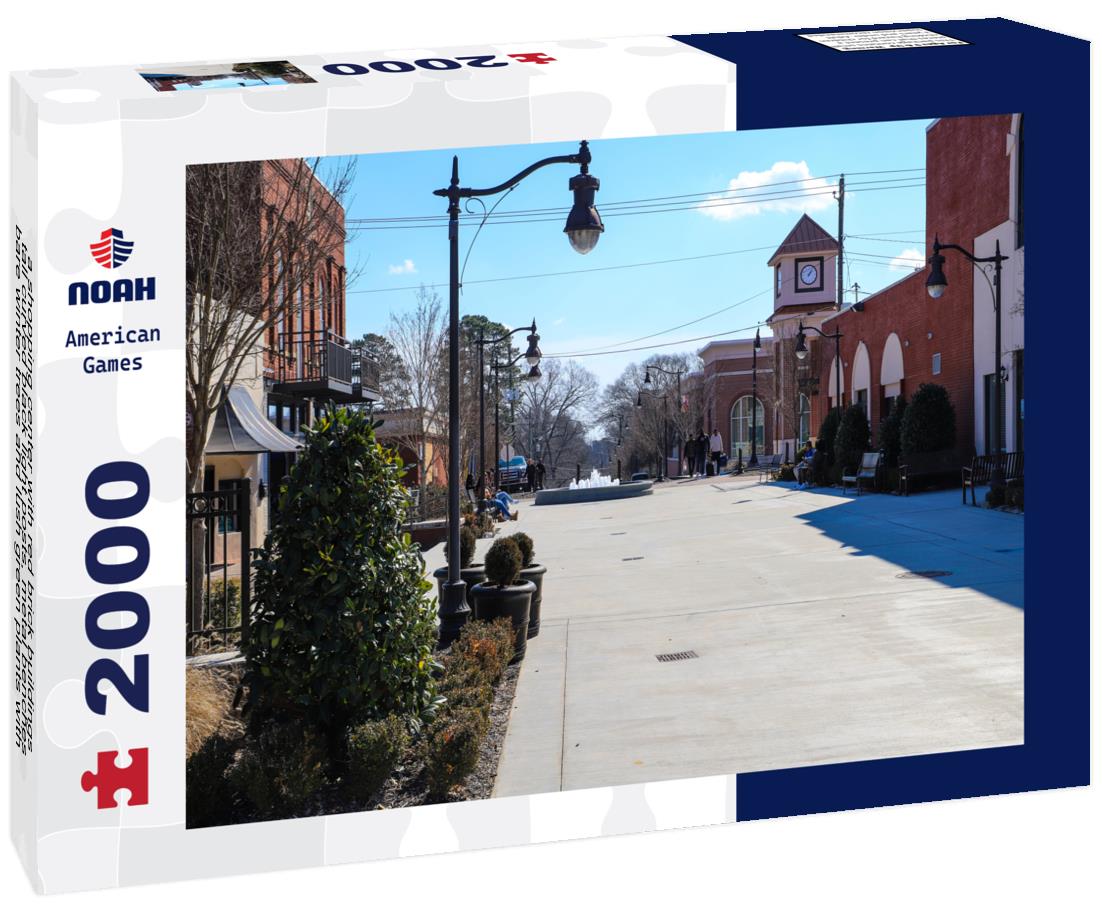 Noah Jigsaw Puzzle shopping center with red brick buildings, tall curved black light posts, metal benches, bare winter trees and lush green plants with blue sky in Douglasville Georgia USA 2000 pieces
