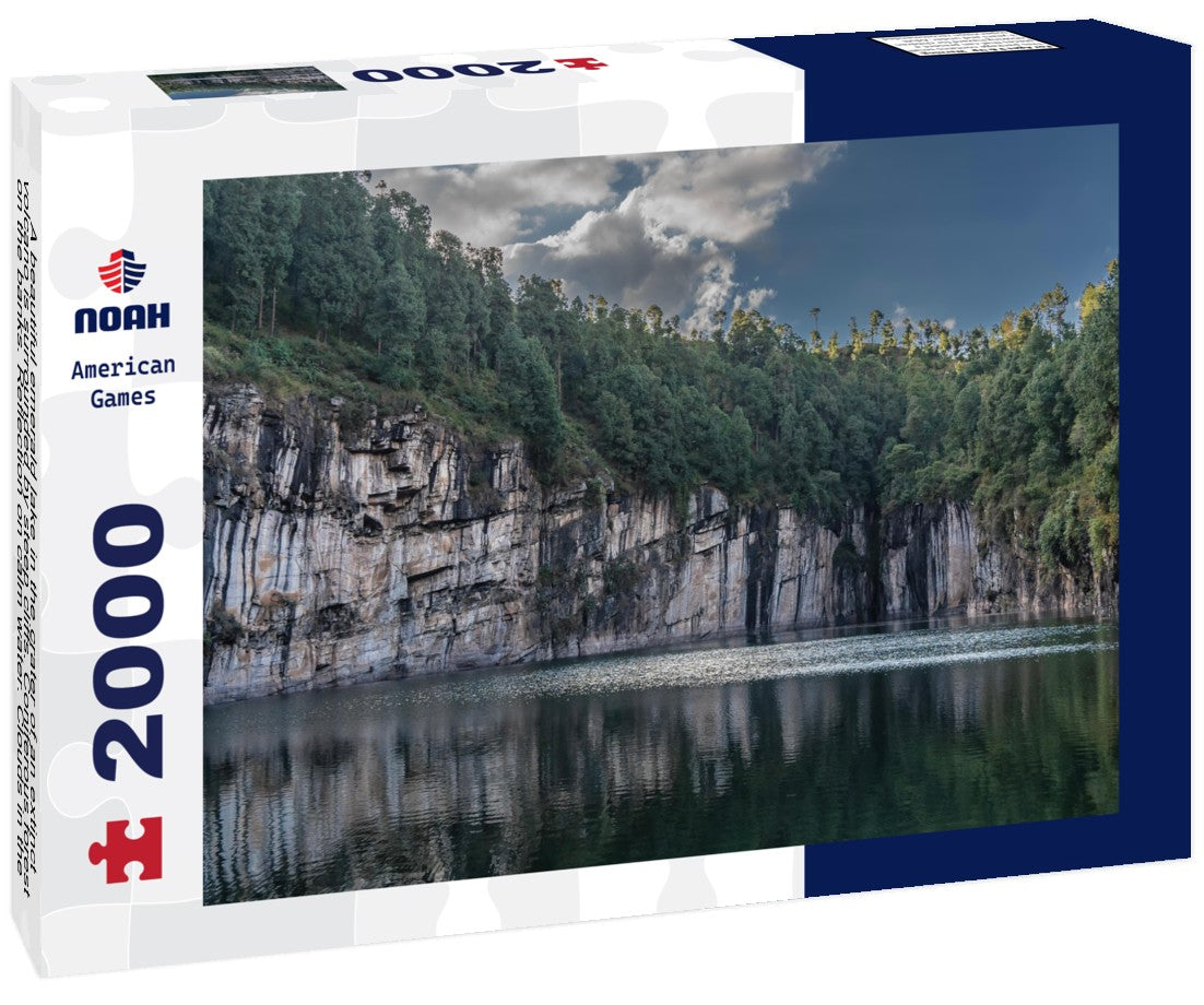 Noah Jigsaw Puzzle A beautiful emerald lake in the crater of an extinct volcano is surrounded by steep cliffs. Coniferous forest on the banks. Reflection on calm water. Clouds in the blue sky. Tritriva lake. Madagascar 2000 pieces