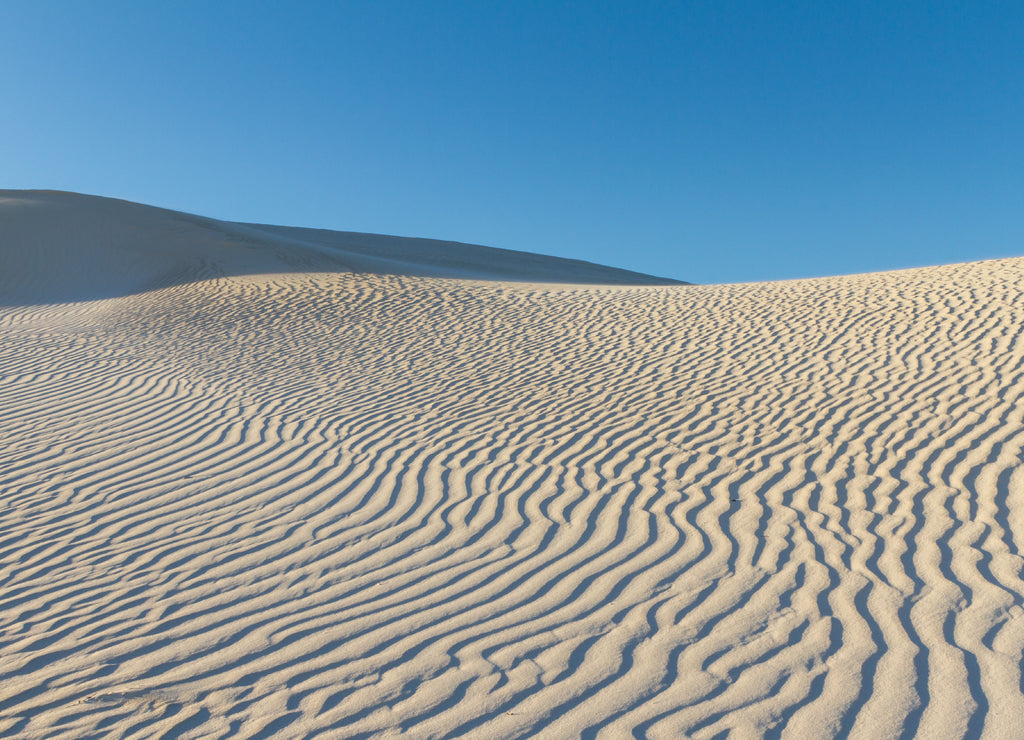 White sand dunes in Western Australia with blue sky