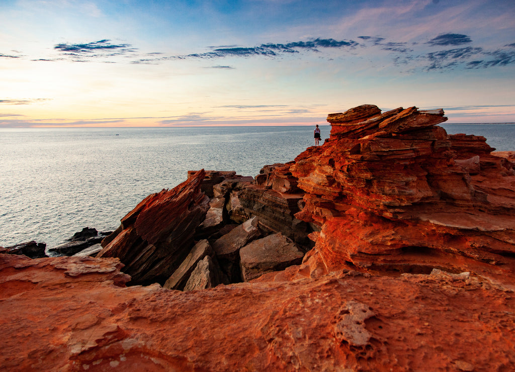 A distant figure looks out across the ocean at Gantheaume Point, Broome