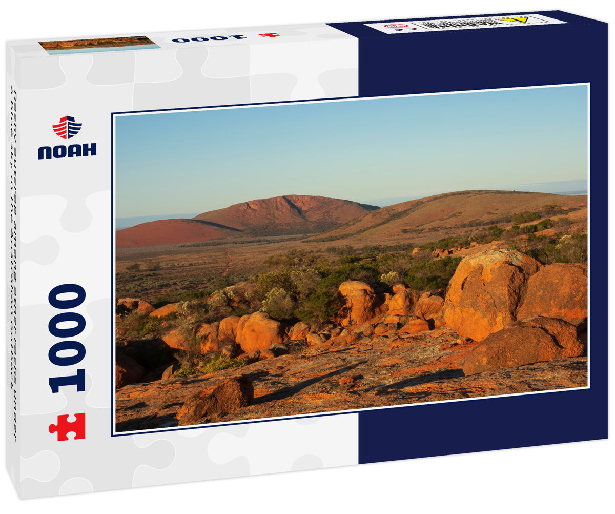 Rocky outcrop among other rocks under a blue sky in the Australian outback