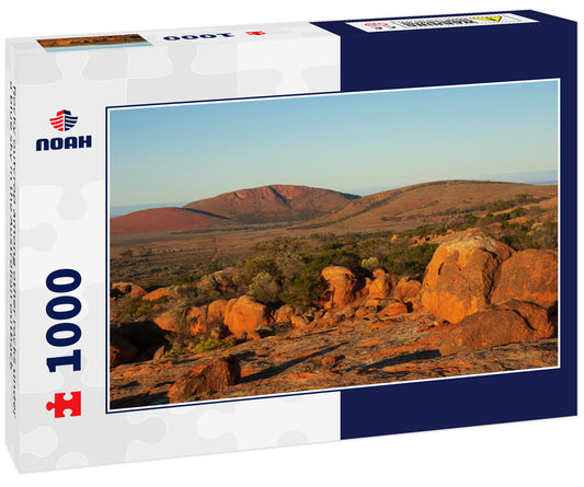 Rocky outcrop among other rocks under a blue sky in the Australian outback