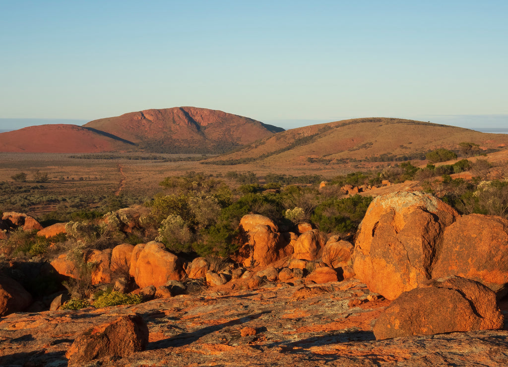 Rocky outcrop among other rocks under a blue sky in the Australian outback