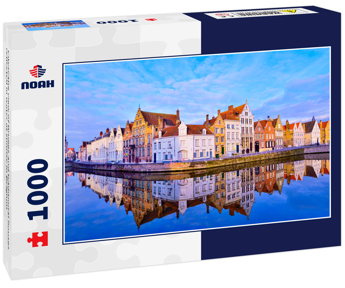 Cityscape view of Bruges and traditional houses reflected in water at sunrise in Belgium