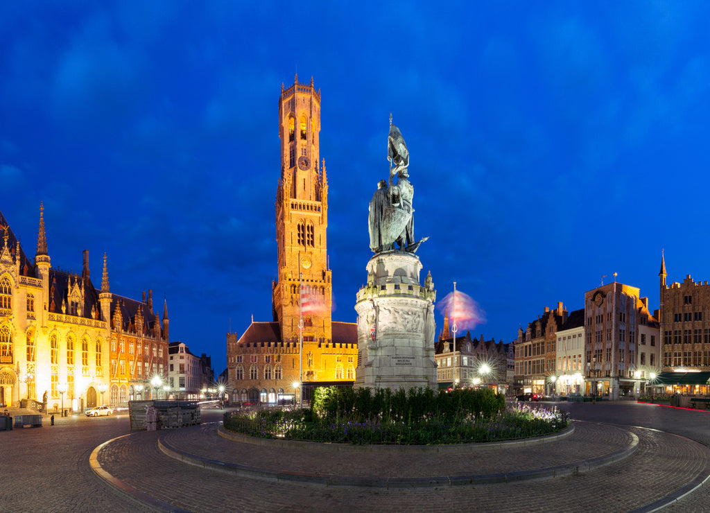 Tower Belfort and statue of Jan Breydel and Pieter de Coninck on the Grote Markt or Market Square during evening blue hour, Bruges, Belgium