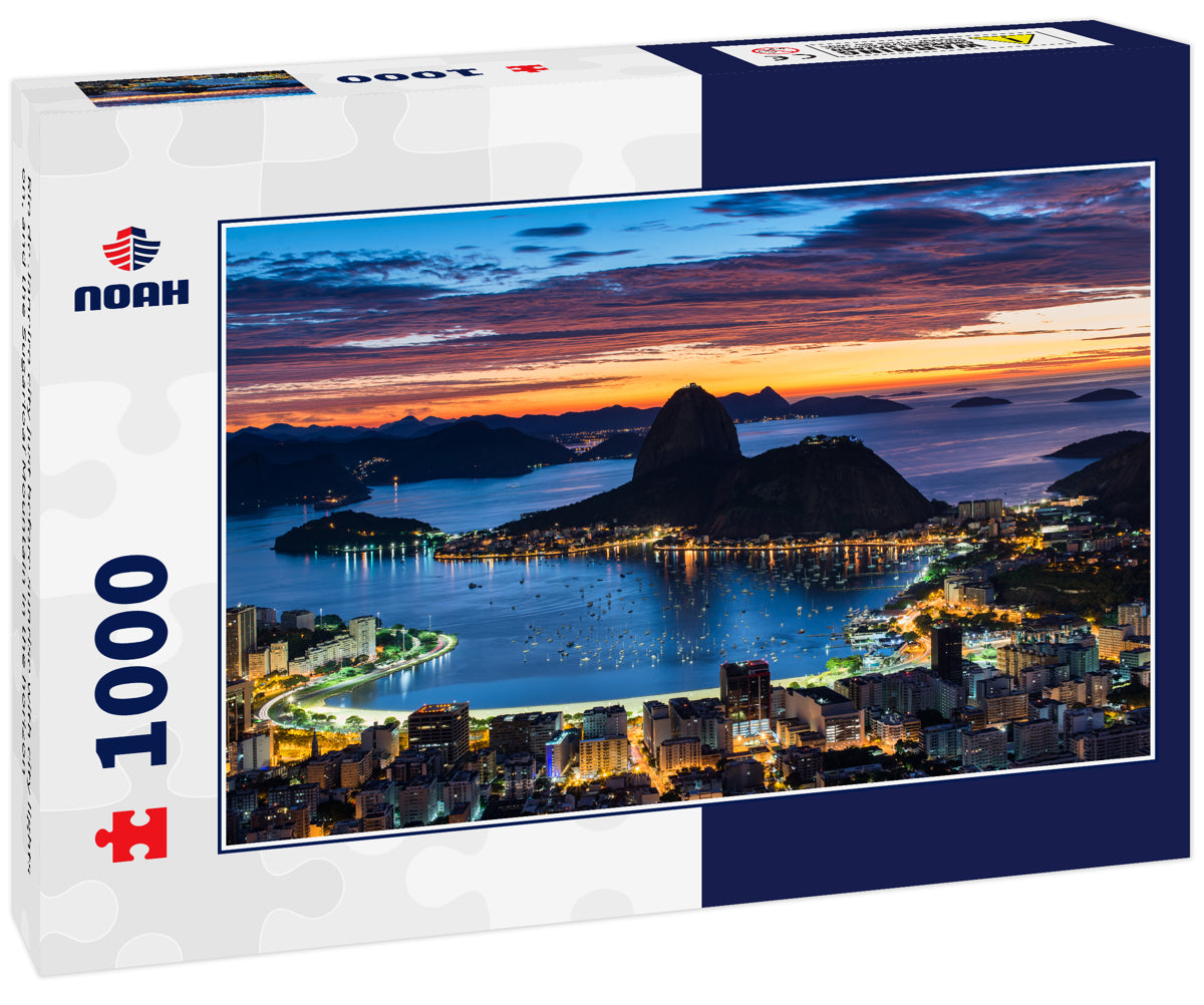 Rio de Janeiro city just before sunrise with city lights on, and the Sugarloaf Mountain in the horizon
