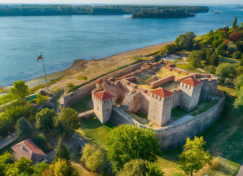 Aerial shot of Baba Vida fortress in Vidin, Bulgaria on the shore of Danube river - impressive and well preserved cultural monument under the golden light of the setting sun
