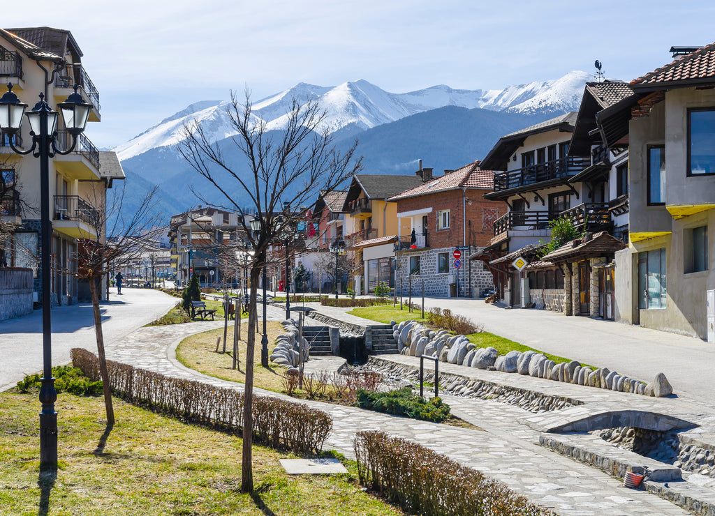 Gotse Delchev street and promenade in the mountain town of Bansko, now the largest mountain resort in Bulgaria. In the background the Pirin mountains