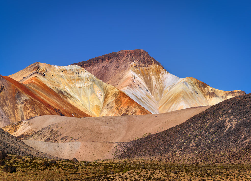 Landscape with the colorful volcano Cerro Cosapilla under blue sky in the north of Chile