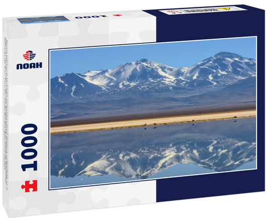 Snow covered Nevado (volcano) Tres Cruces reflecting in a high-altitude lake Laguna Santa Rosa in Parque Nacional Nevado de Tres Cruces, Chile Andes, Atacama desert