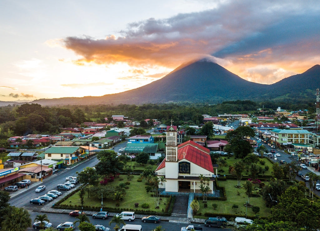 Beautiful aerial view of the Fortuna town, church, park and the Arenal volcano at sunset in Costa Rica