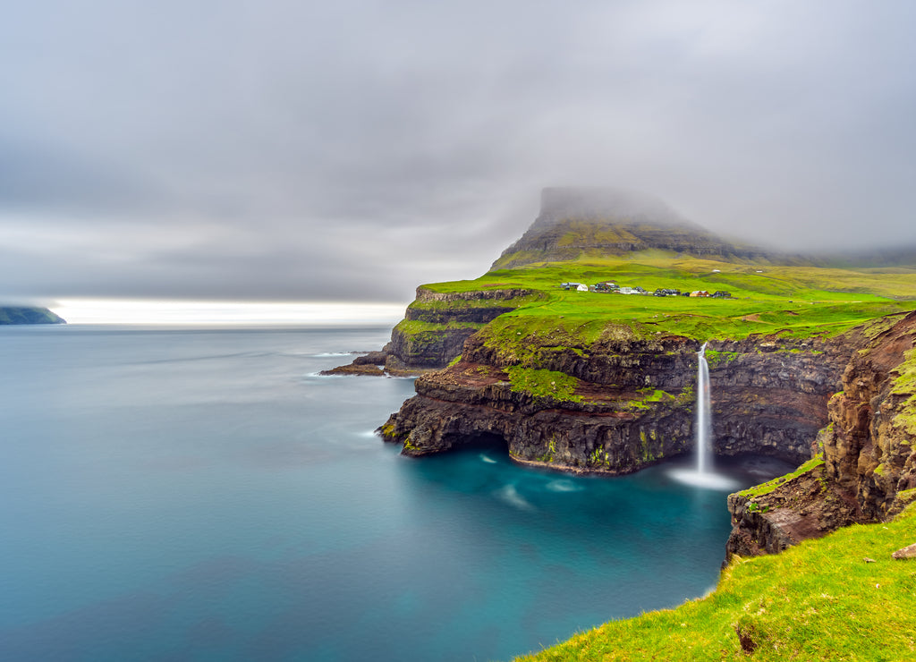 Gasadalur waterfall long exposure in Faroe Islands, misty day