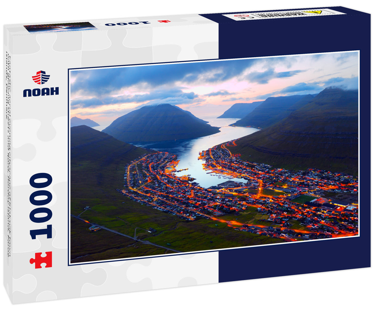 Fantastic aerial evening cityscape of Klaksvik town with glowing streets and fjord, Bordoy island, Faroe islands, Denmark