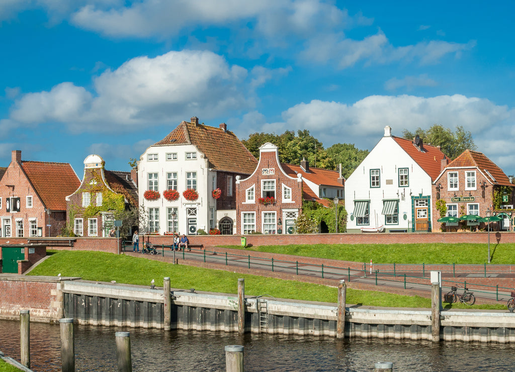 Facades of historic houses at Sielstrasse in the fishing harbour of Greetsiel, Lower Saxony, Germany