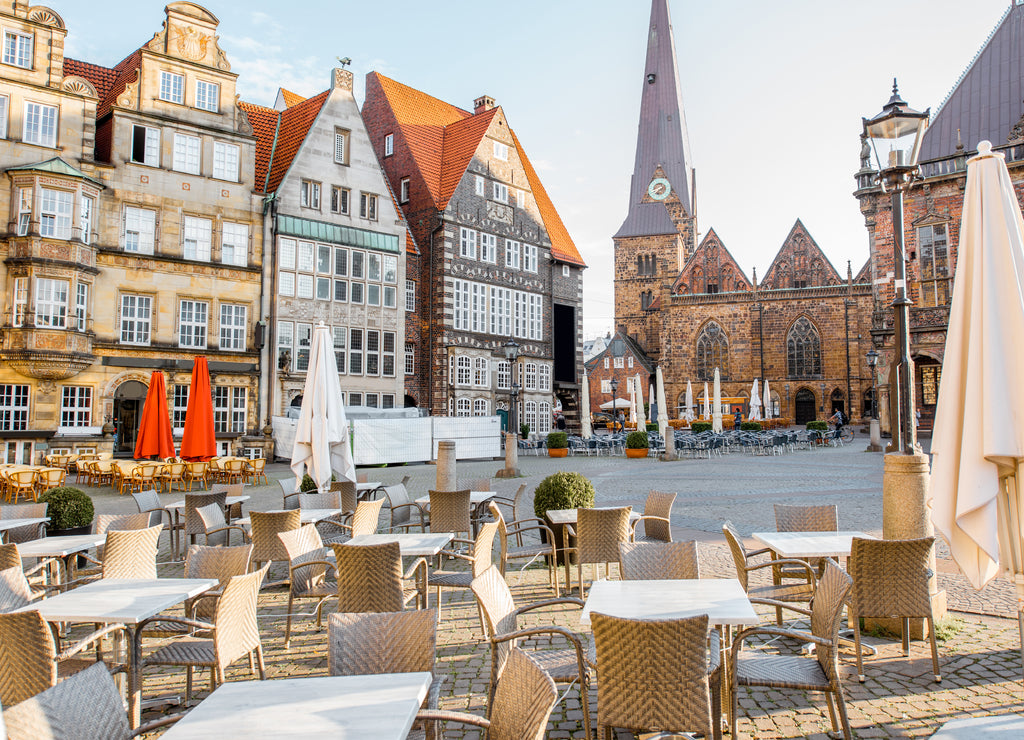 View on the Market square with cafe terrace and Our Lady church during the morning light in Bremen city, Germany