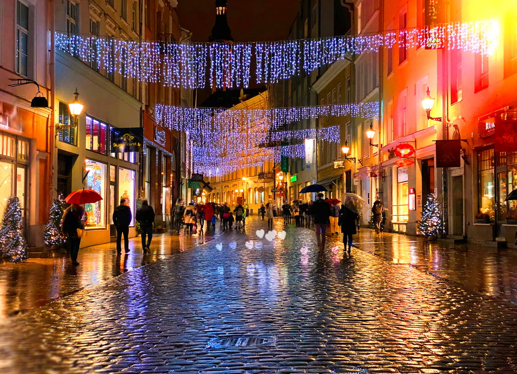 Rainy Autumn Travel to Europe in the City Christmas Tallinn Old town street night light people walking with umbrellas rain drops reflection on wet asphalt soft blurred light lifestyle Tilt Shift