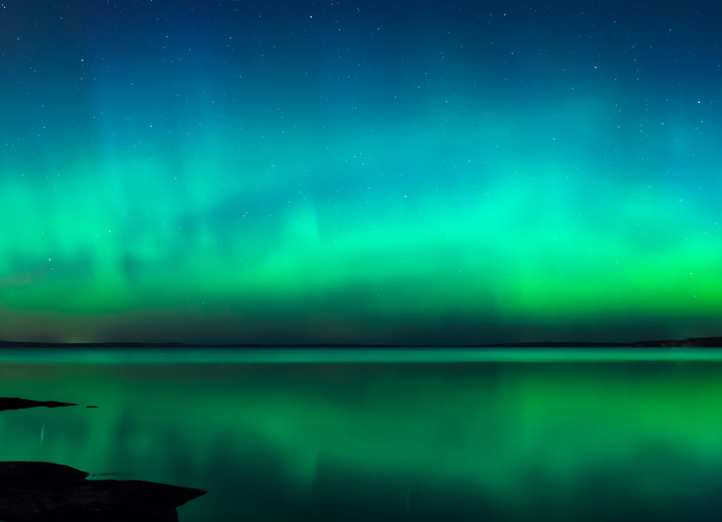 Northern lights over lake in Finland