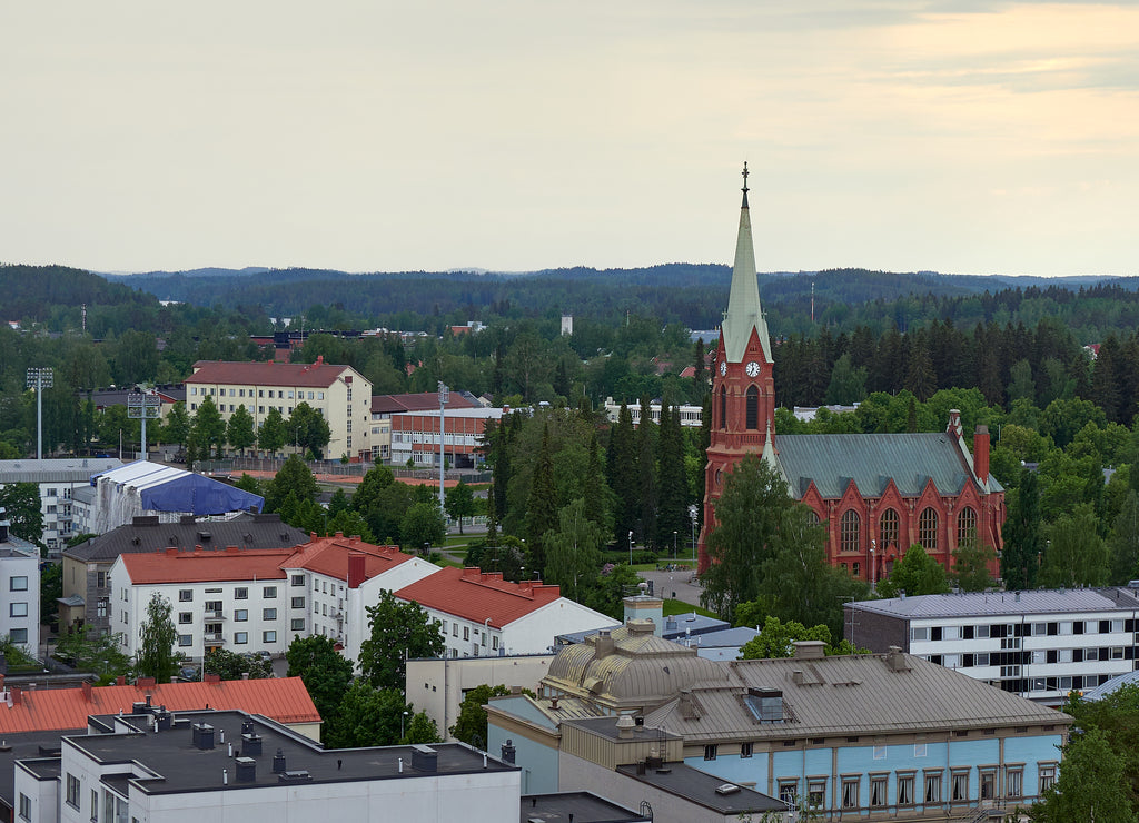 Panorama of the city of Mikkeli in Finland before the rain in summer: roofs of houses horizon forest lutheran church