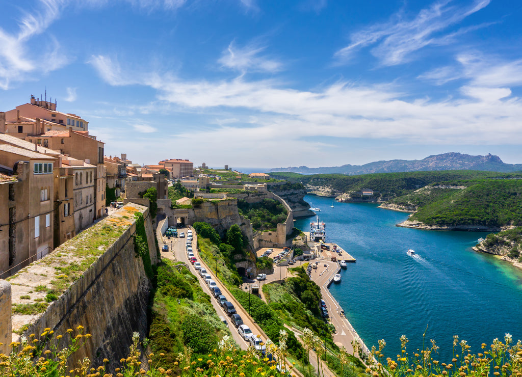 Landscape on Corsica island, beautiful view of Calvi town with castle on hill in summertime, France
