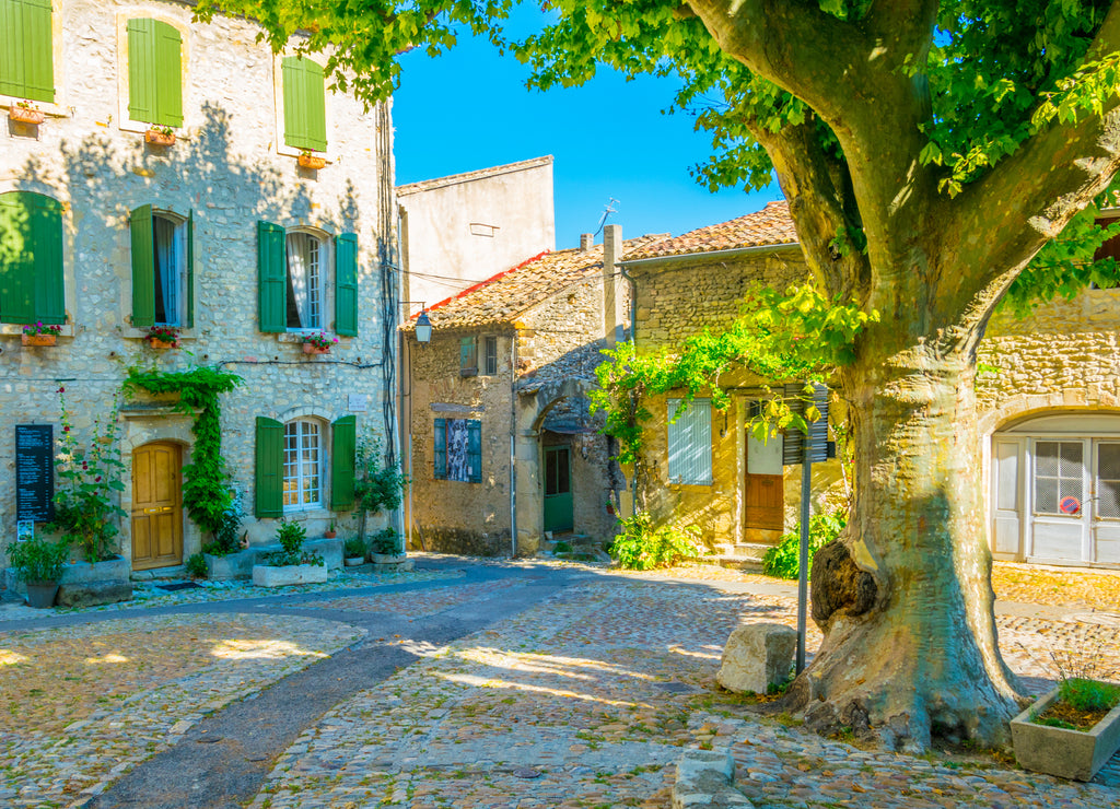 a narrow street in the old town of Vaison-la-Romaine in France