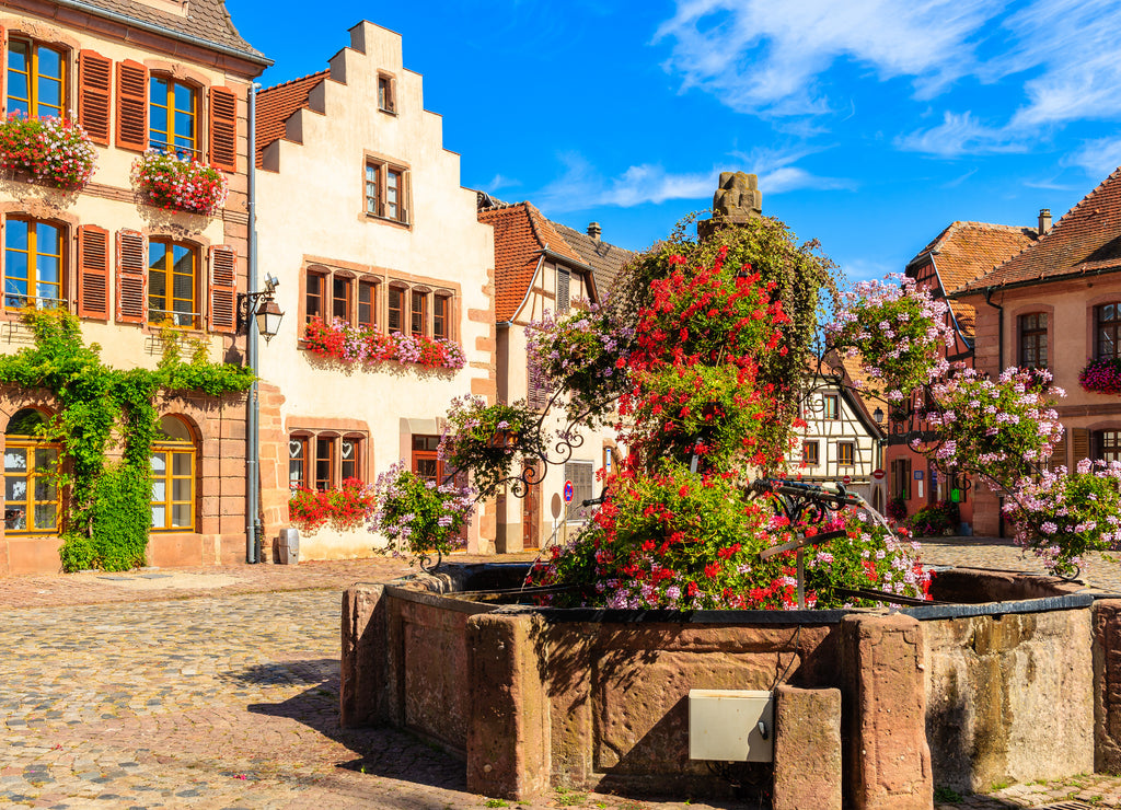 Colorful houses on square in Bergheim village on Alsatian Wine Route, France