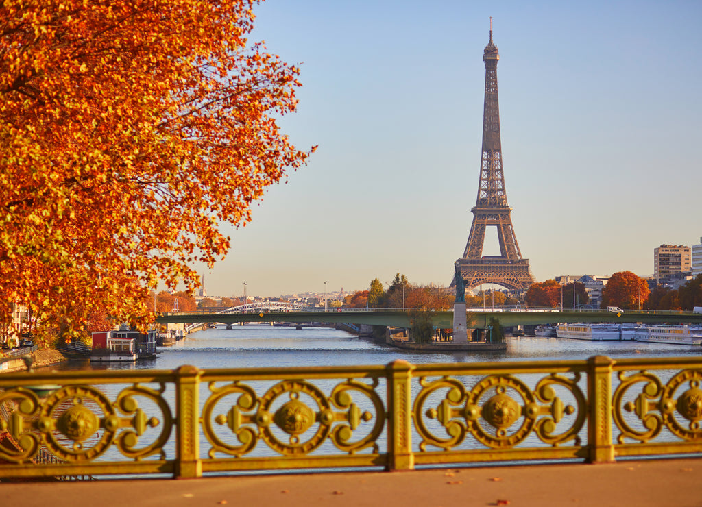 Scenic view of the Eiffel tower over the river Seine from Mirabeau bridge on a bright fall day in Paris