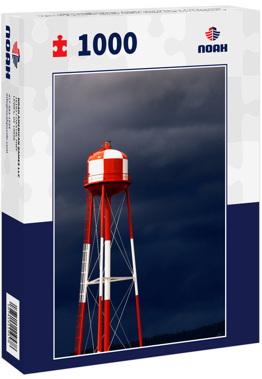 A modern red and white water tower against a cloudy, stormy sky in Spokane Valley, Washington, USA