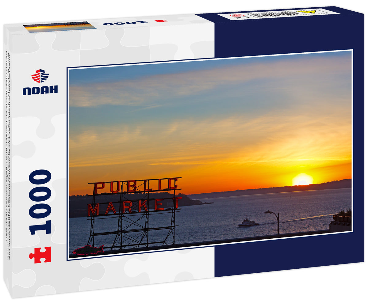 Spectacular sunset over Puget Sound photographed from the Pike Public Market in Seattle, Washington, USA. Winter sunset, water, mountains on horizon and Public Market neon sign