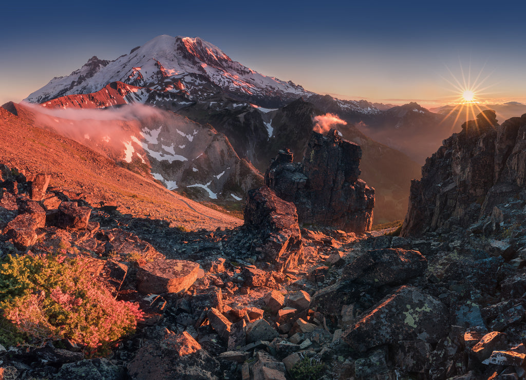 Morning light high above the cloud layer on Mount Rainier. Beautiful Paradise area, Washington state, USA in the fall with snow on Mount Rainier on a sunny day and morning with blue sky. Cascade Range