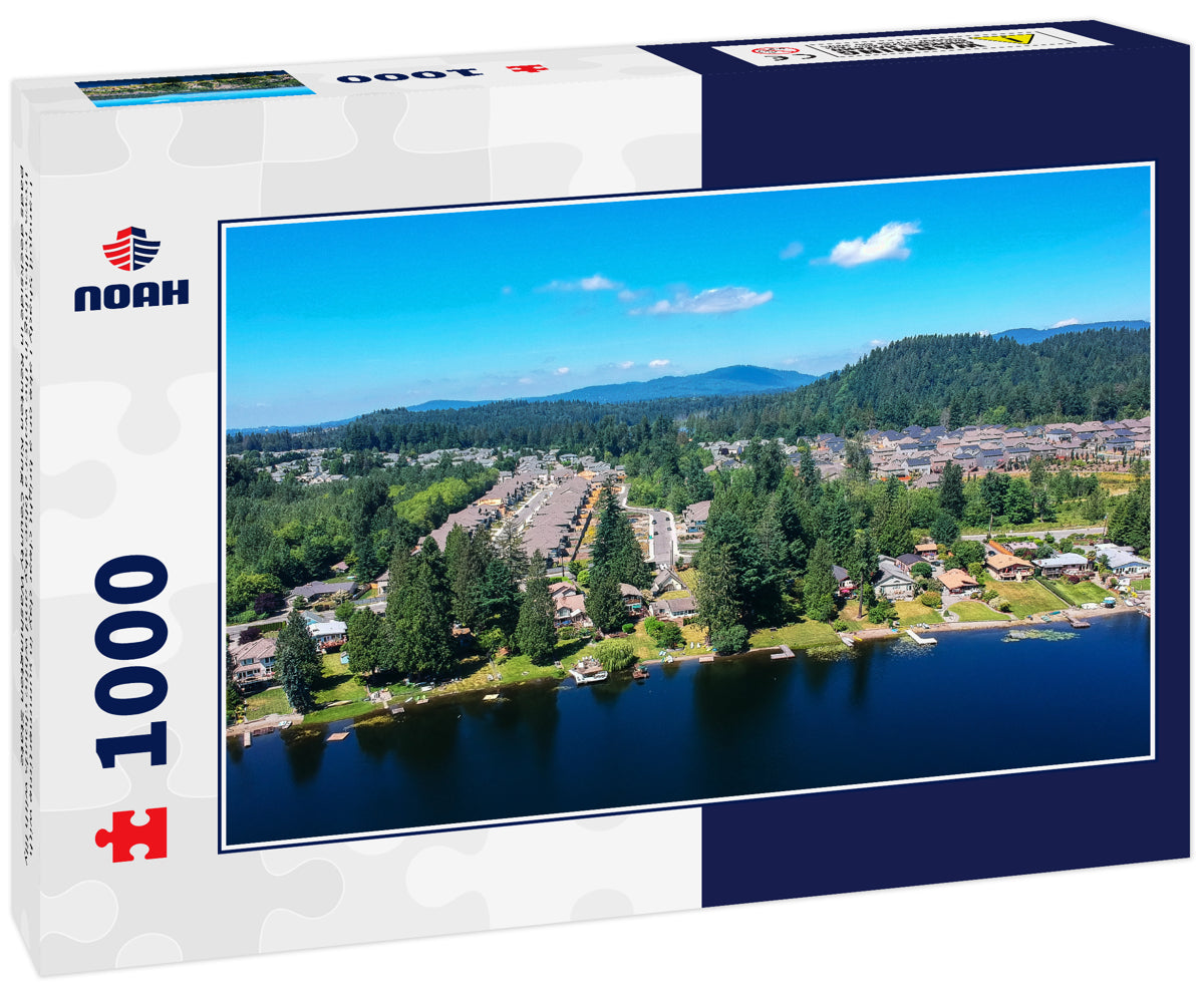 Tranquil Shady Lake on a bright clear day in summertime with trees reflecting in the water a blue sky and white clouds with lily pads dockside in Renton King County Washington State