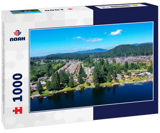 Tranquil Shady Lake on a bright clear day in summertime with trees reflecting in the water a blue sky and white clouds with lily pads dockside in Renton King County Washington State